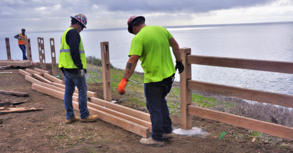 Workers installing woodcrete rails