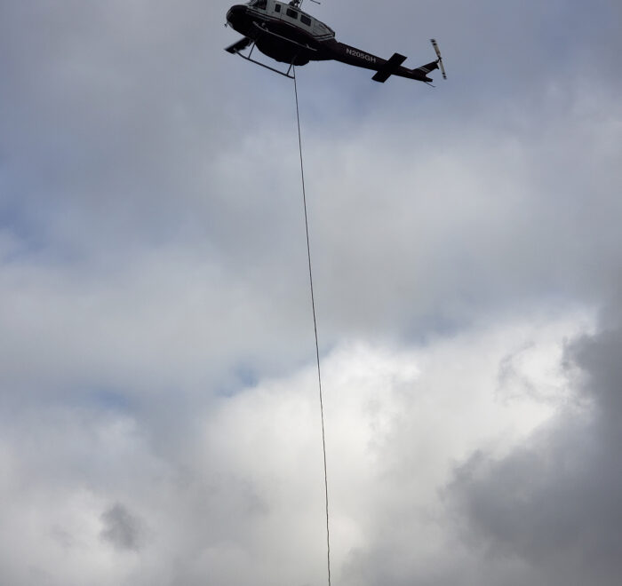 Flying helicopter with a hanging rope tied to it