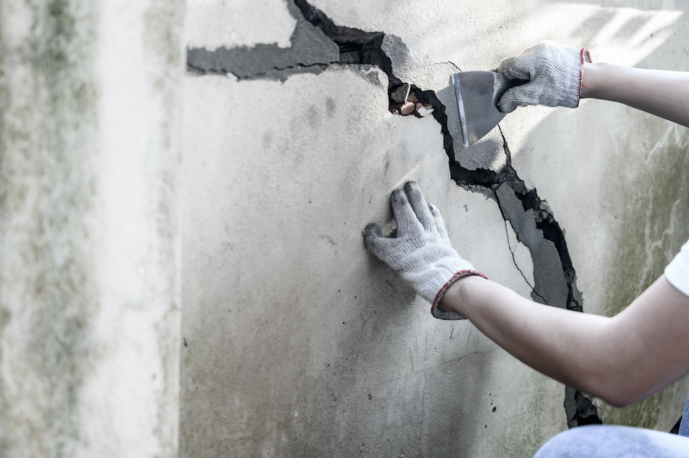 Person repairing their precast concrete wall