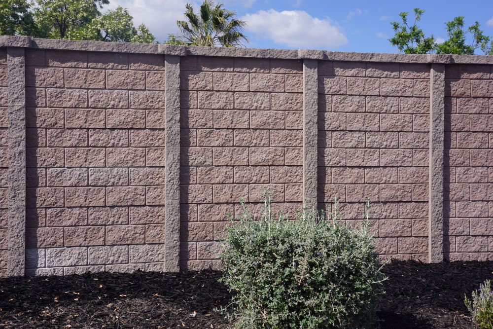 Precast concrete sound barrier wall surrounding the perimeter of a residential complex.