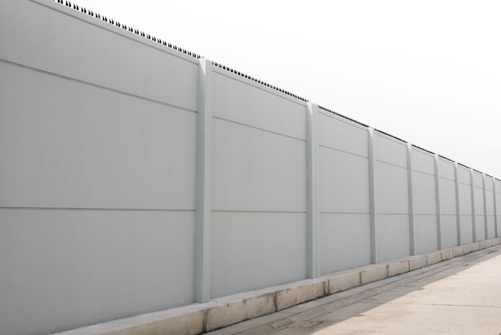 Precast concrete wall serving as a protective barrier around a property.