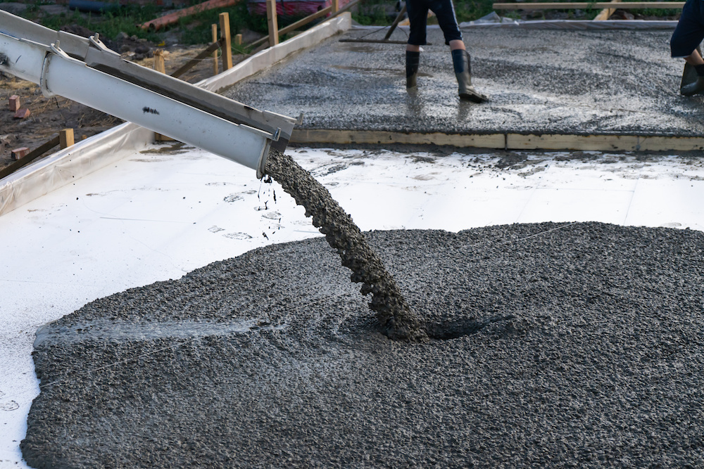 Construction workers pouring concrete for precast concrete