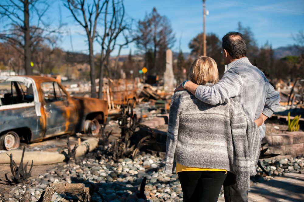 Elderly couple watching their house after fire